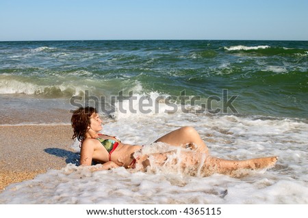 girl sunburning in surf on the sea coast