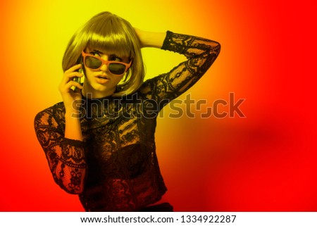 Girl with sunglasses  use the phone, abstract light