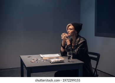 A Girl Suspected Of Distributing Drugs Sits At A Table In An Interrogation Room