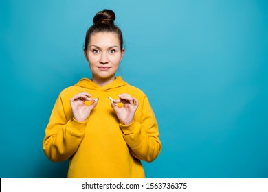 girl in a sweatshirt holds a broken cigarette and smiles, Copy space - Powered by Shutterstock