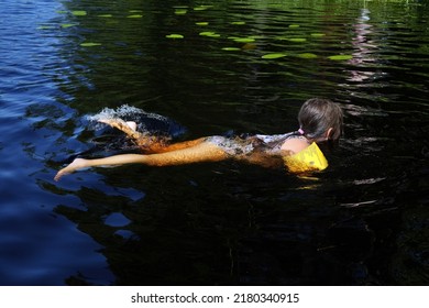 Girl Swimming With Her Water Wings.