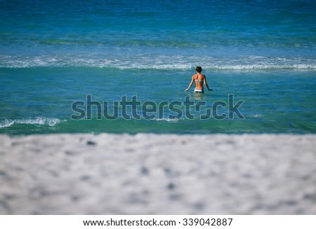 Girl swimming in paradise beach in Cuba