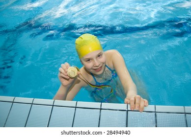 Girl in the swimming pool with medal - Powered by Shutterstock