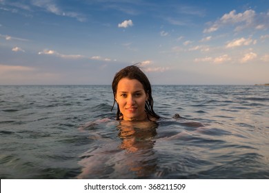 Girl Swimming Underwater In Lake