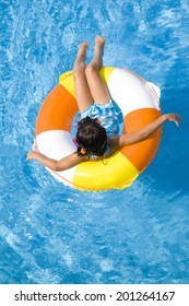 Girl swimsuit floating in the pool float