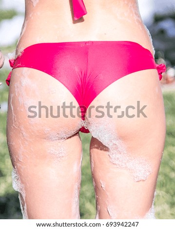 Similar – Anonymous woman applying sunscreen by the poolside