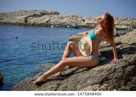 Girl in a swimsuit on the beach, the Adriatic coast, the mountains of Croatia
