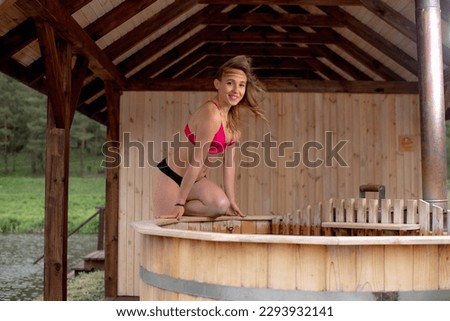 a girl in a swimsuit in a spa in a hot jacuzzi tub
