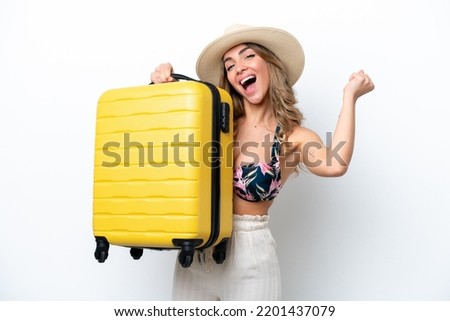Girl in swimsuit in summer holidays isolated on white background in vacation with travel suitcase
