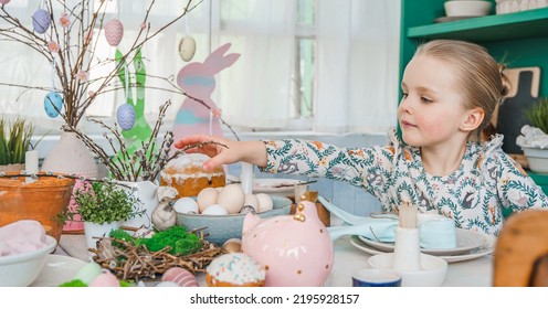 Girl At Table With Easter Decoration. Celebration In Kitchen.Tablescape For Home Easter Holiday.Family Religious Traditional Festive Christianity,catholic Food.Colored Eggs,cake,fun Bunny,candy Sweet.