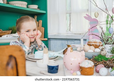 Girl At Table With Easter Decoration. Celebration In Kitchen.Tablescape For Home Easter Holiday.Family Religious Traditional Festive Christianity,catholic Food.Colored Eggs,cake,fun Bunny,candy Sweet.