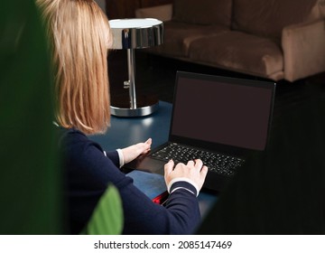 
Girl At The Table With A Laptop. Without A Face. Remote Access Concept. Close-up. Selective Focus