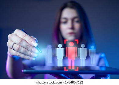 A Girl With A Tablet In Her Hands Chooses One Person From Several. Personnel Decision. Personnel Manager. Employment. Dismissal. Personnel Policy Of The Company.