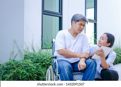 The Girl Takes Care Of The Male Patient Sitting On The Wheelchair. She Wants Him To Come Back Strong Again.