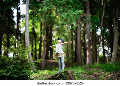 Girl Taking Deep Breath In The Woods