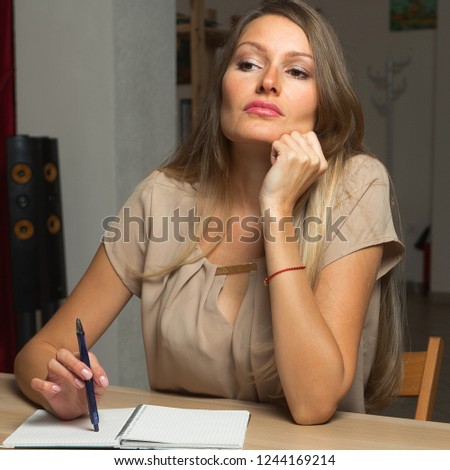 A girl taking notes in the diary.