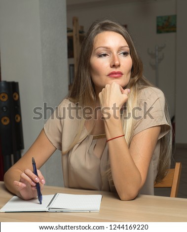 A girl taking notes in the diary.