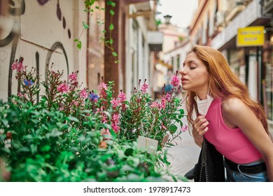 Girl Taking Off Mask And Smelling Flowers