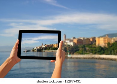 Girl taking pictures on a tablet in Bastia, Corsica, France. - Powered by Shutterstock