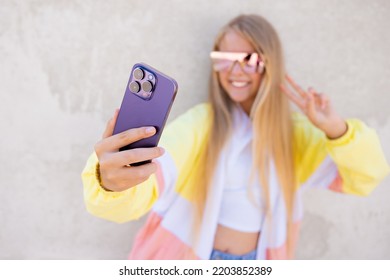 Girl taking selfie with mobile phone