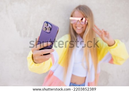 Girl taking selfie with mobile phone