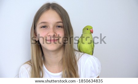 Girl Talk Parrot, Happy Kid Playing her Pet, Child Plays Bird at Home, Funny Indian Ring-Necked Parakeet Birds Cage Family
