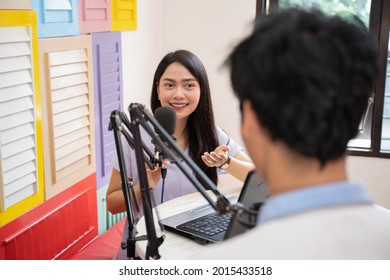 A Girl Talking And Chatting With A Guy In Front Of A Microphone During Podcast