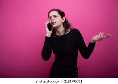 The girl is talking on the phone and waving her hand. The girl doesn't understand anything - Shutterstock ID 2191795721