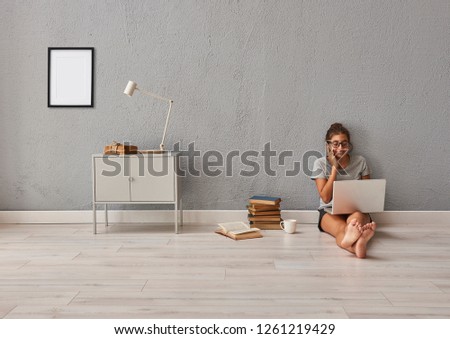 Girl and technology interior concept, grey stone wall, grey cabinet and book style.