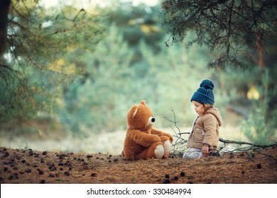 Girl With Teddy Bear Walking In The Woods