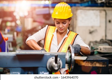 Girl Teen Worker African American Working Labor In Industry Factory With Heavy Steel Machine.