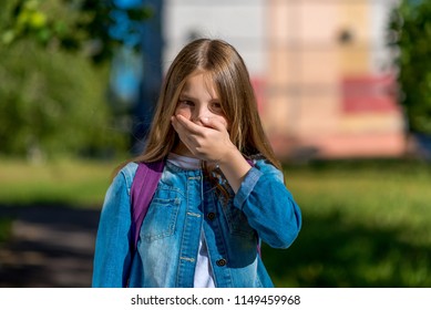 Girl Teenager After School. In The Summer In The Park In Nature. The Hand Closes His Mouth. The Concept Of Nausea, Vomiting, Do Not Say. Emotions Are Silent, Quiet, Without Sound.