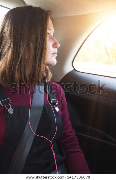 girl teenager in the car wearing a seat belt.\
road safety\
