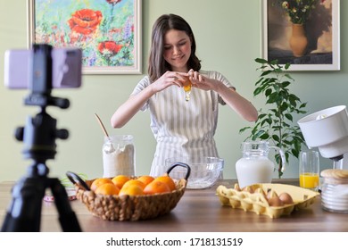 Girl Teenager Food Blogger Cooking Orange Pancakes At Home In Kitchen. Ingredients Products Flour, Oranges, Milk, Sugar, Breaks Eggs. Cooking Hobbies Girls, Teens And Children Followers Channel