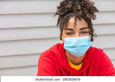 Girl teenager teen mixed race biracial African American female young woman wearing face mask in Coronavirus COVID-19 pandemic - Powered by Shutterstock