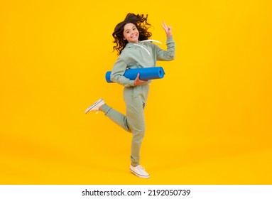 Girl Teenager In Tracksuit. Run And Jump. Happy Cute Child In A Yellow Sports Suit On A Yellow Background. Sportswear Advertising Concept.