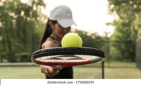 girl tennis player holding a racket and ball.woman playing tenes