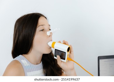 Girl testing breathing function by spirometry in doctors office. Diagnosis of respiratory function in pulmonary disease.