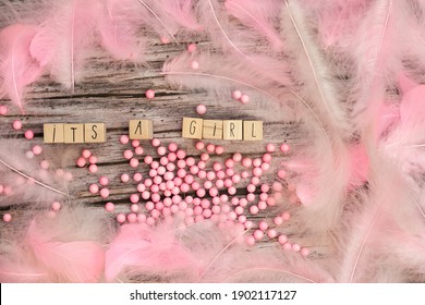 Its a Girl text on wooden background texture with pink feathers for baby invitation shower or newborn, girl announcement greeting card, top view colorful design pastel colors - Powered by Shutterstock