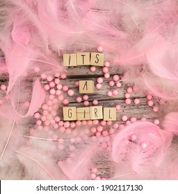 Its A Girl Text On Wooden Background Texture With Pink Feathers For Baby Invitation Shower Or Newborn, Girl Announcement Greeting Card, Top View Colorful Design Pastel Colors