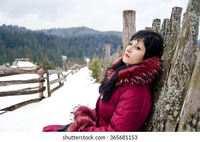 The Girl Thought Sitting Near The Fence In The Winter