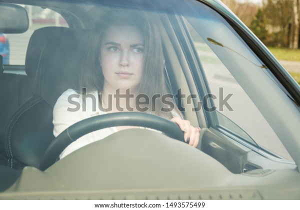 The girl thoughtfully drives the car, drives the\
car. Woman driving.