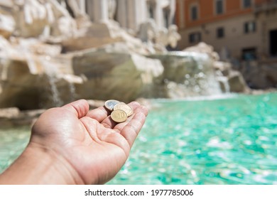 Girl Throwing Coin At Trevi Fountain For Good Luck. Hands Keeping Coin. Trevi Fountain, Rome, Italy.