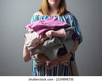 the girl is tired of household chores, the housewife is stressed during work, ironing clothes - Shutterstock ID 2159898735
