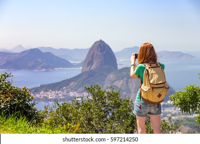 Girl Tourist Taking A Photo On A Smartphone Pao De Acucar. Rio De Janeiro. Brazil
