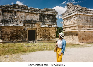 Girl tourist walks through the ancient Mayan complex Chichen Itza.A popular tourist destination in the Yucatan - Chichen Itza complex 