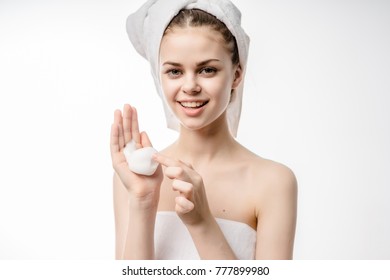 girl in a towel with foam in her hand
