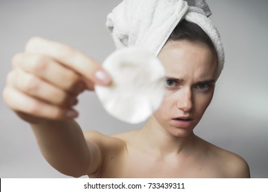 Girl With A Towel On Her Head Showing A Dirty Cotton Pad