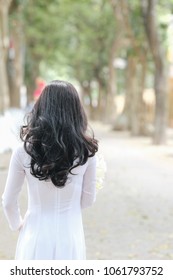 The girl in traditional Vietnamese dress with lily flowers ( Hoa loa Ken ) in April every year in Hanoi, Vietnam
