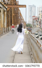 The girl in traditional Vietnamese dress with lily flowers ( Hoa loa Ken ) in April every year in Hanoi, Vietnam